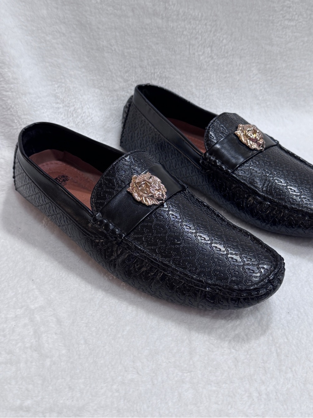 Black Textured Leather Slip-On Loafers with Gold Crest Accent